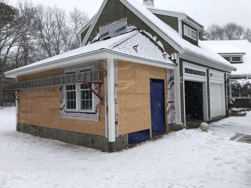 Home garage addition sheathed exterior in the winter