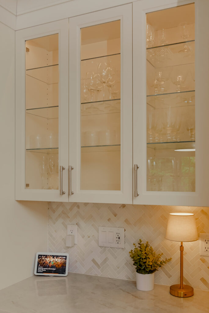 Kingston kitchen remodel nook with outlets and illuminated glassware cabinet