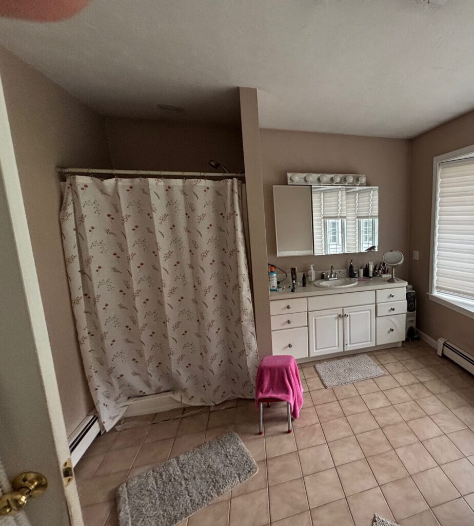 Original bathroom with shower and vanity area prior to remodeling